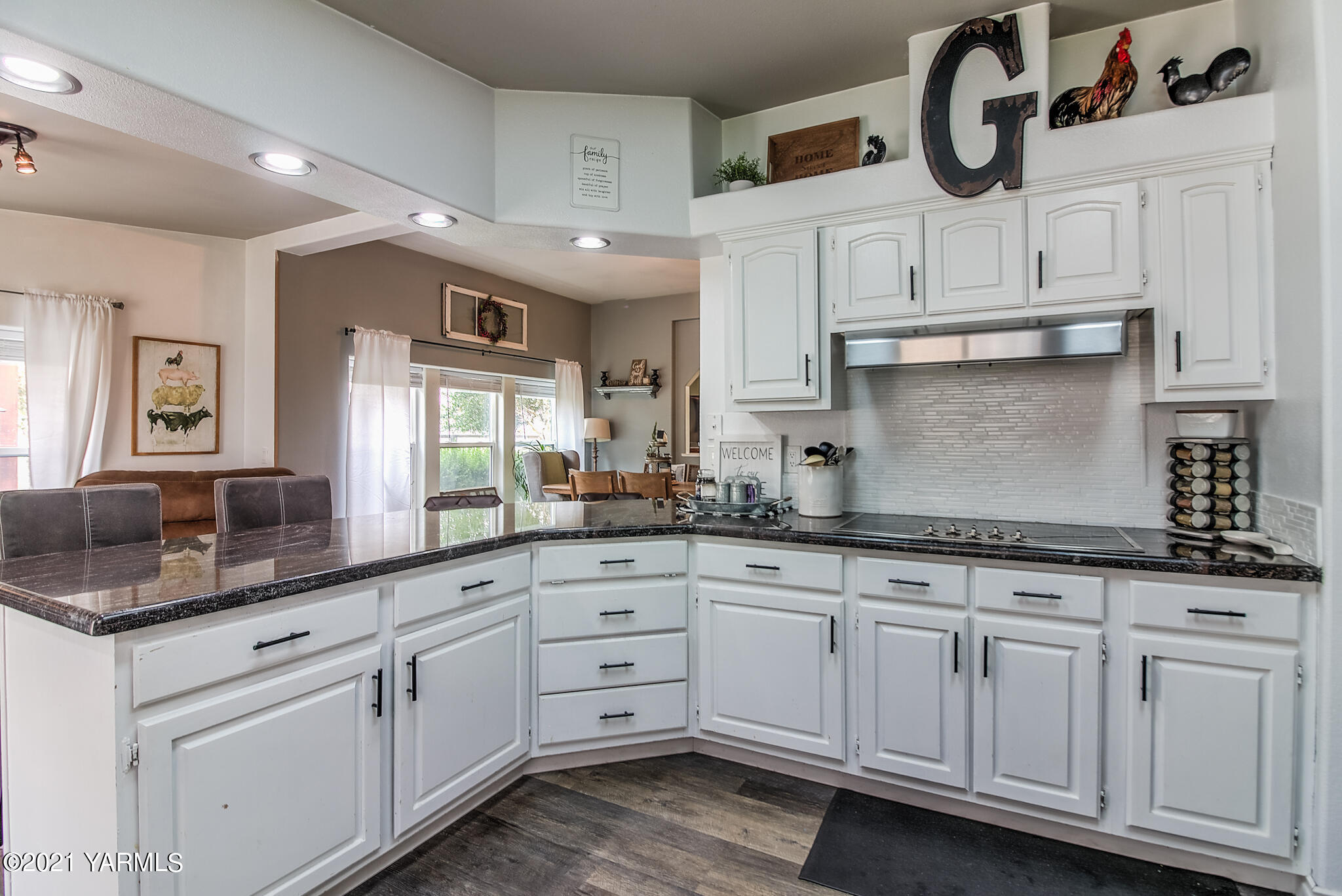 251 Wellner Road Outlook, WA 98938 - Photo 14 of 45 a kitchen with granite countertop white cabinets and sink