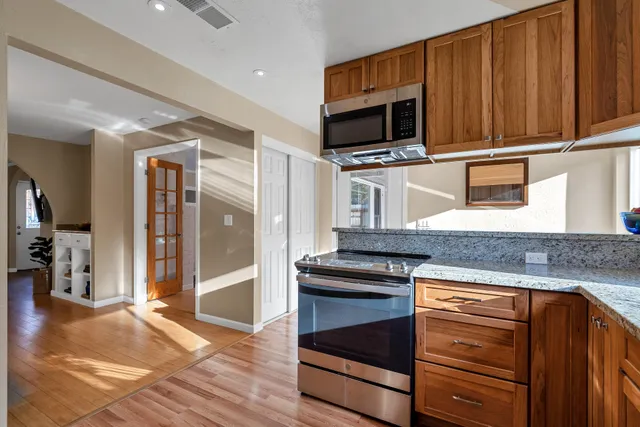a kitchen with stainless steel appliances granite countertop a stove and a microwave