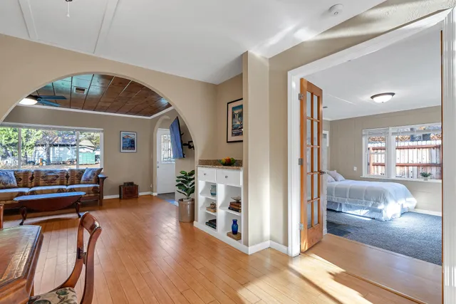 a bed sitting in a bedroom next to a window