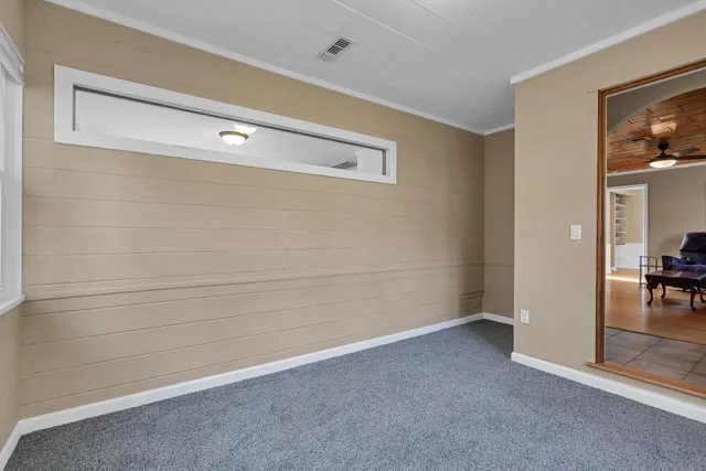 a bathroom with a granite countertop toilet a sink and a mirror