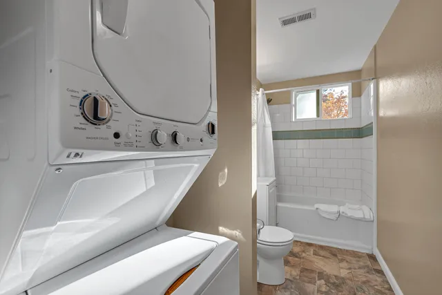 a bathroom with a toilet a sink and bathtub