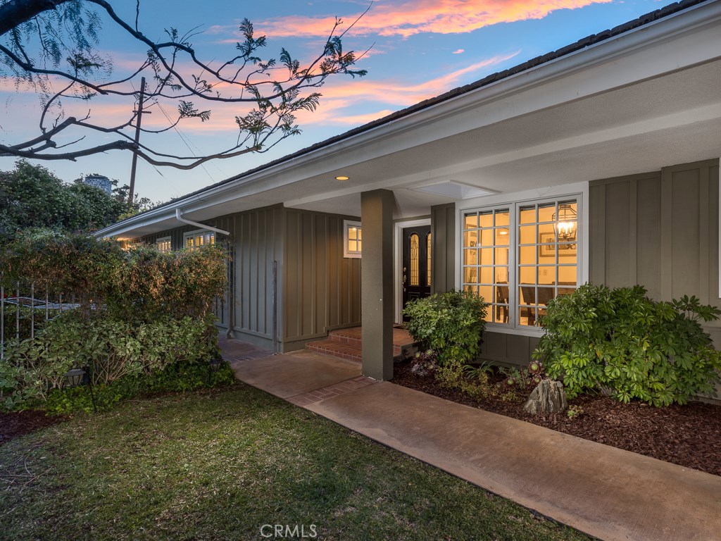 a view of a house with potted plants