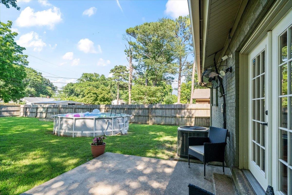 4686 Bill Knight Road Millington, TN 38053 - Photo 25 of 29 Private backyard featuring a concrete patio, French doors, and a brick exterior