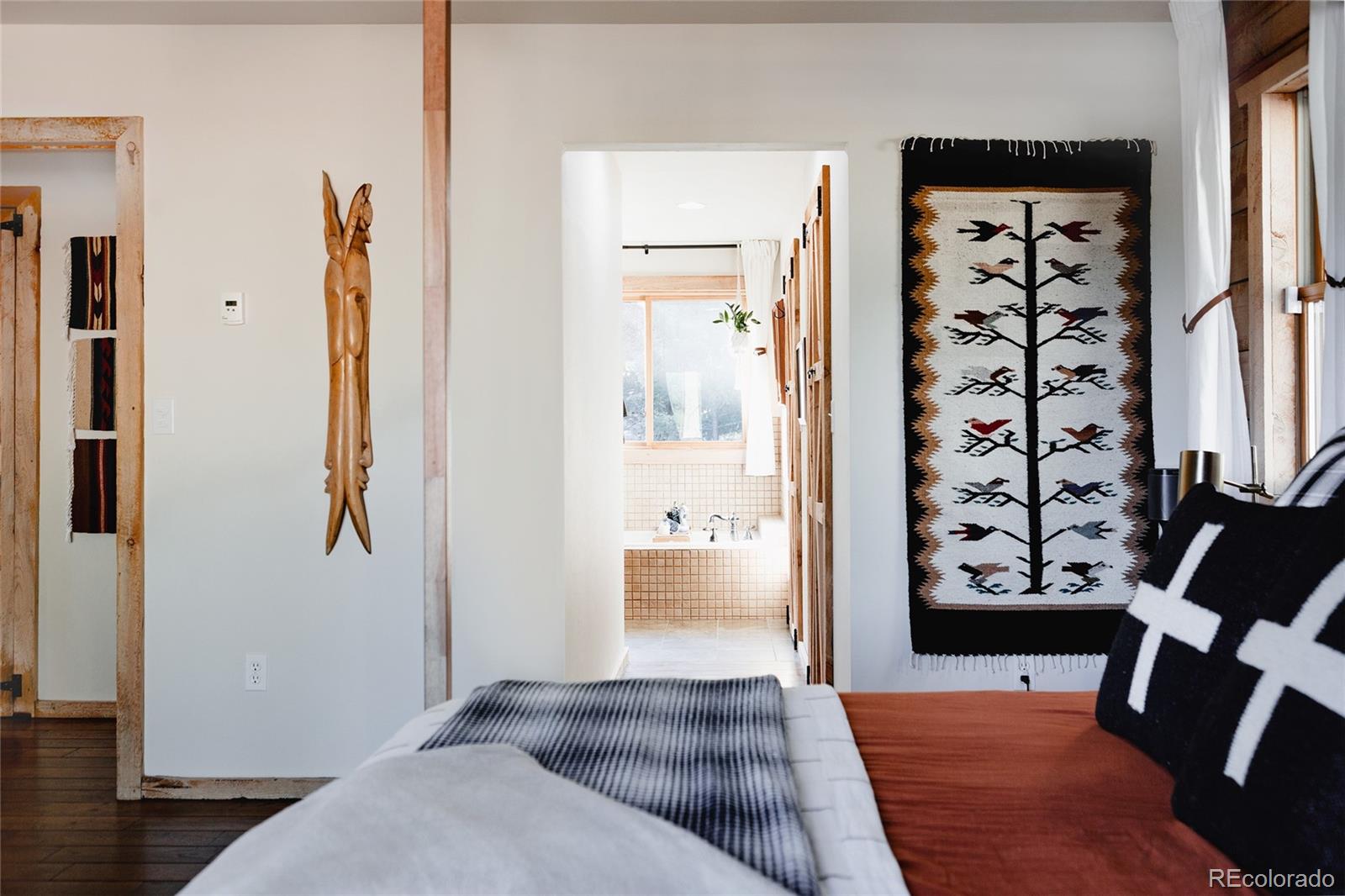 13574 Baird Road Conifer, CO 80433 - Photo 12 of 50 a view of a bedroom with wooden floor and windows