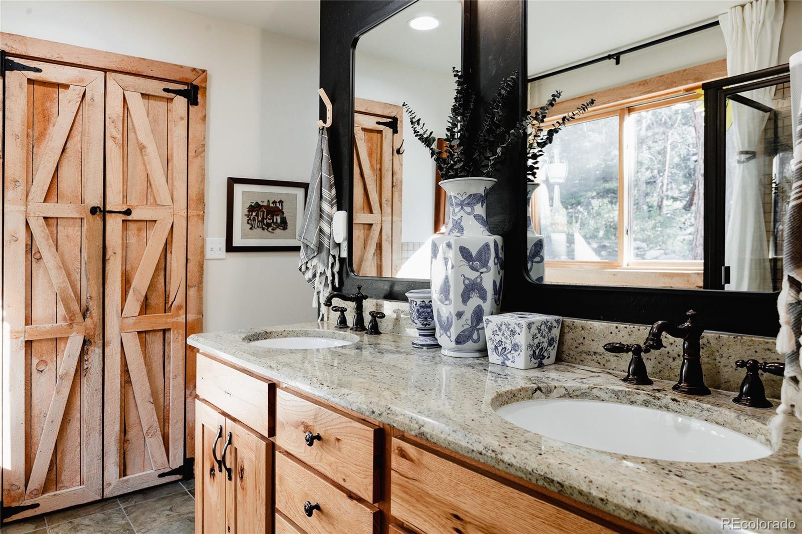 13574 Baird Road Conifer, CO 80433 - Photo 15 of 50 a bathroom with a granite countertop sink and a mirror