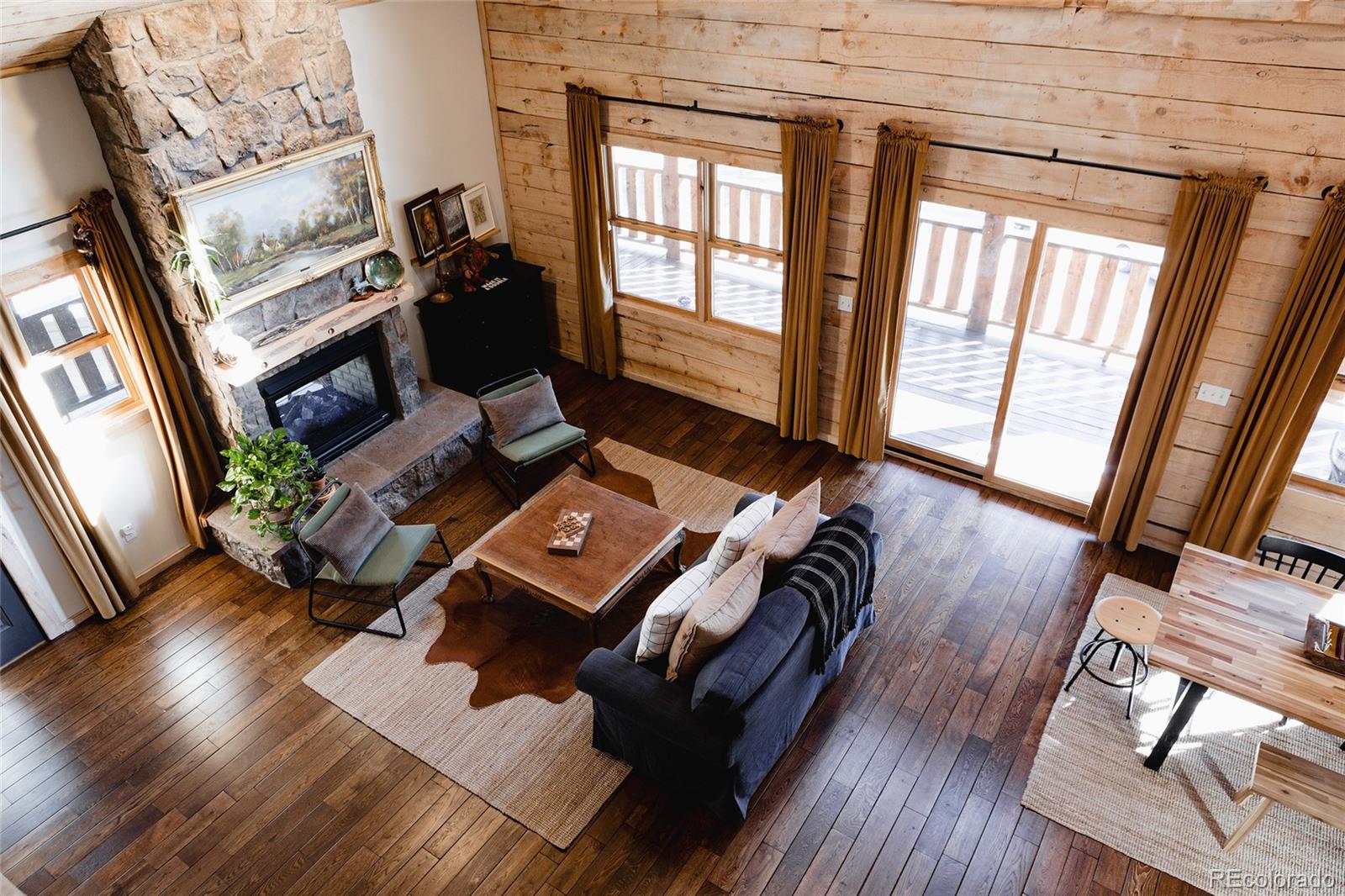 13574 Baird Road Conifer, CO 80433 - Photo 20 of 50 a living room with furniture and a fireplace