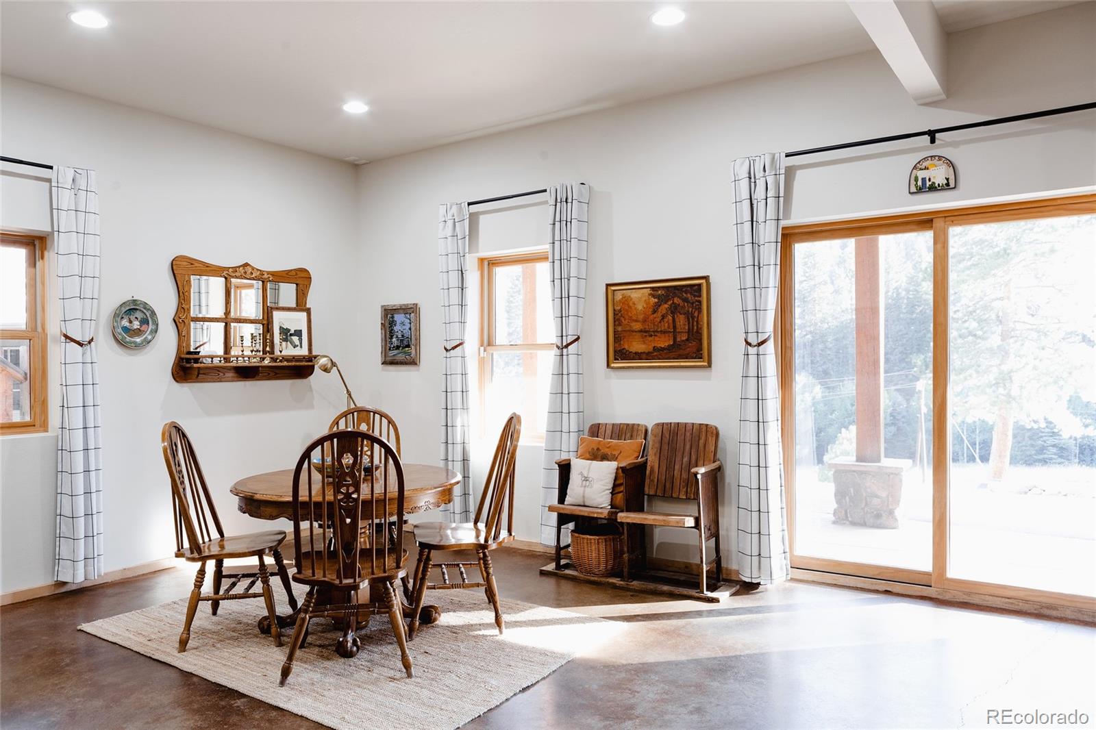13574 Baird Road Conifer, CO 80433 - Photo 22 of 50 a dining room with furniture and windows