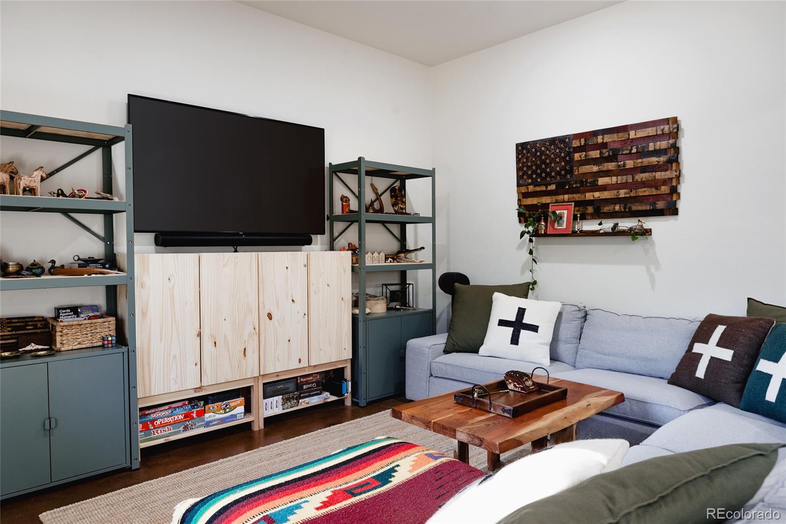 13574 Baird Road Conifer, CO 80433 - Photo 24 of 50 a living room with furniture and a flat screen tv