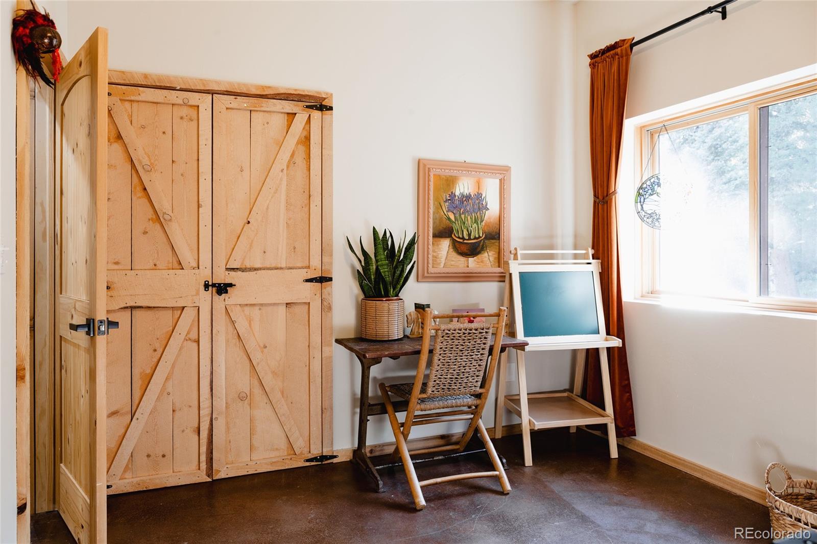 13574 Baird Road Conifer, CO 80433 - Photo 29 of 50 a dining room with a window and furniture