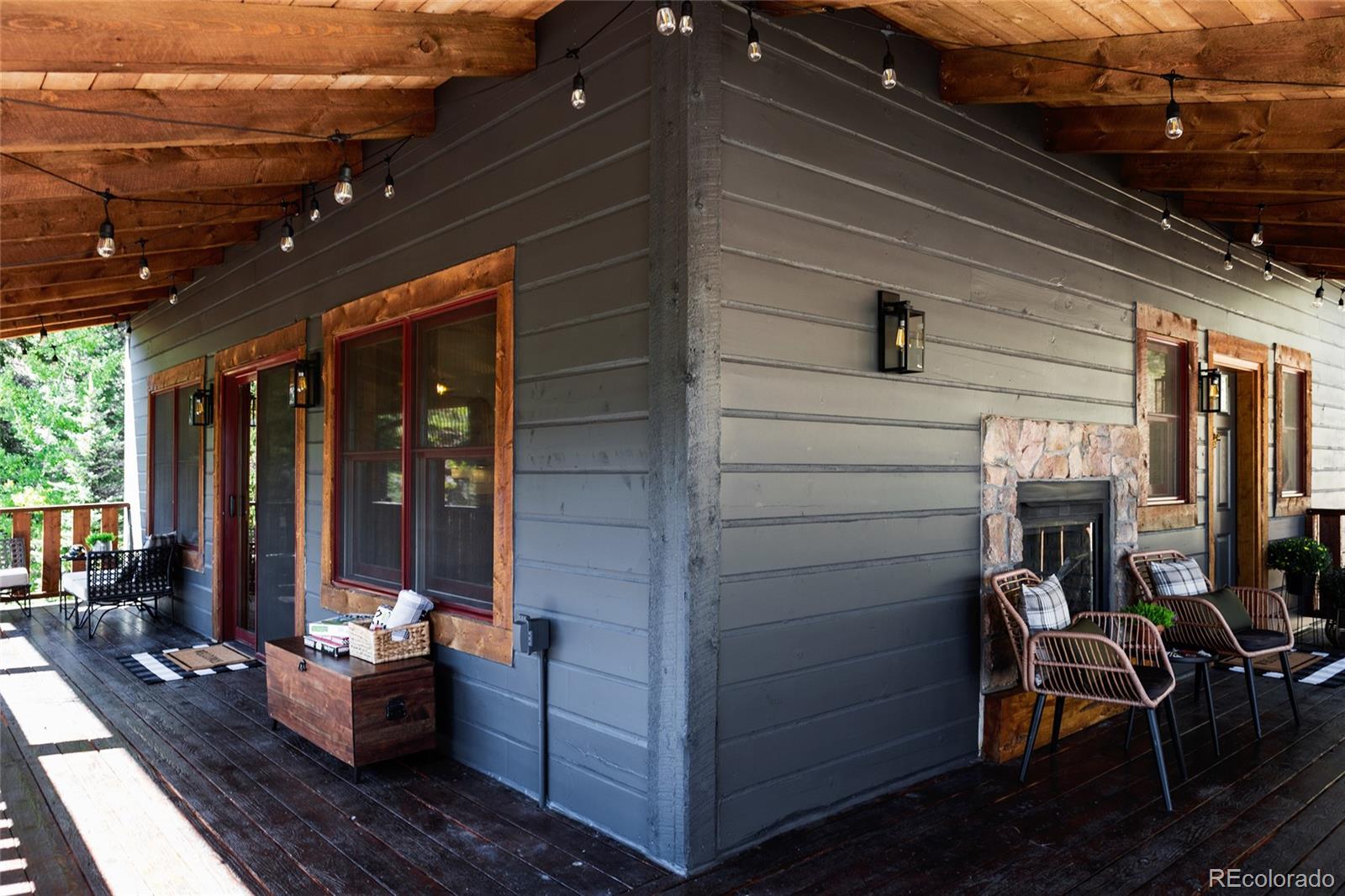 13574 Baird Road Conifer, CO 80433 - Photo 3 of 50 a view of a patio with table and chairs and potted plants