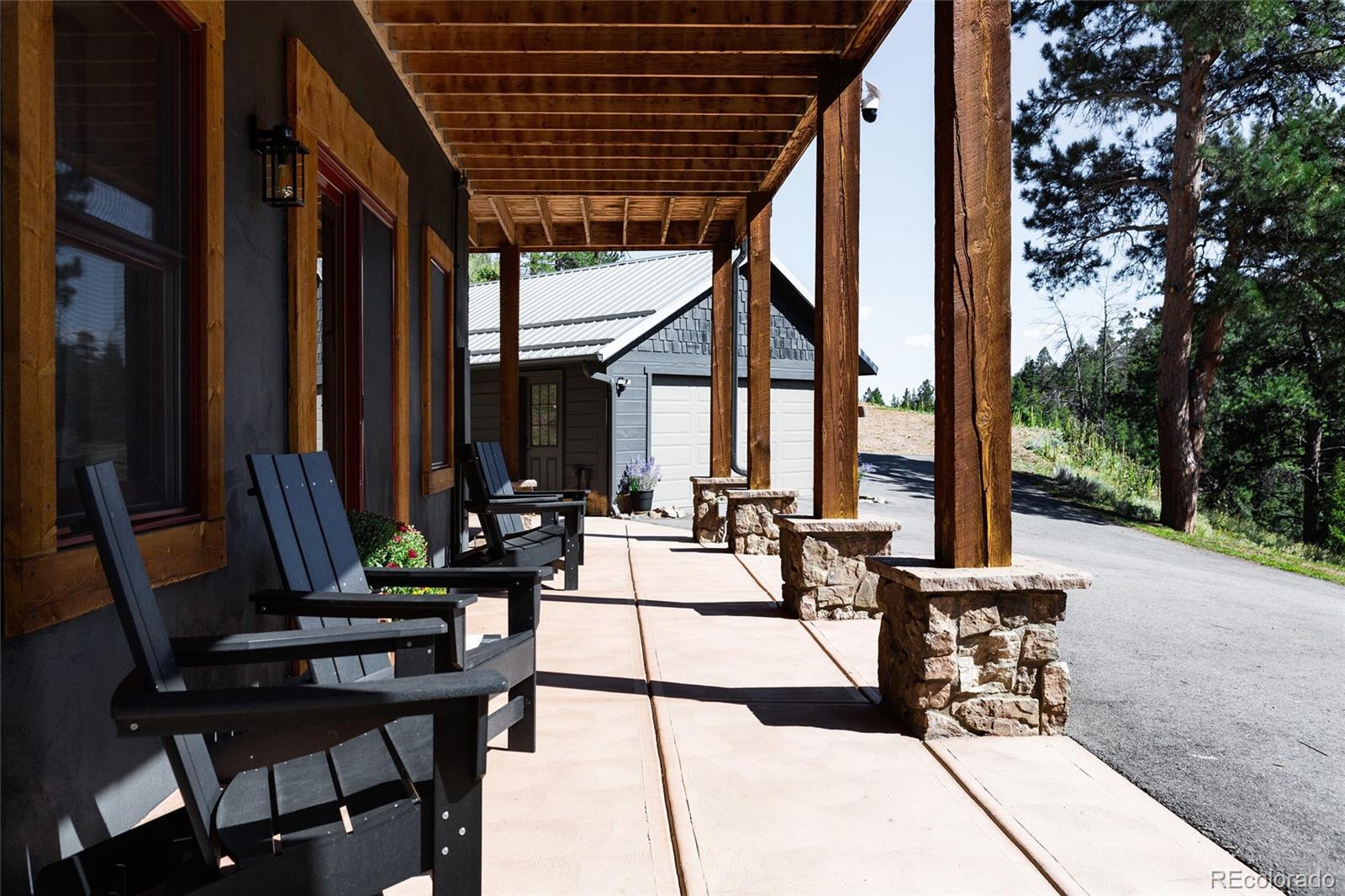 13574 Baird Road Conifer, CO 80433 - Photo 31 of 50 a view of a patio with chairs and tables in patio