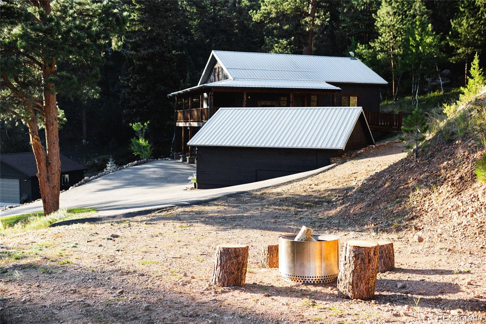13574 Baird Road Conifer, CO 80433 - Photo 33 of 50 a view of a dry yard covered with snow in the background