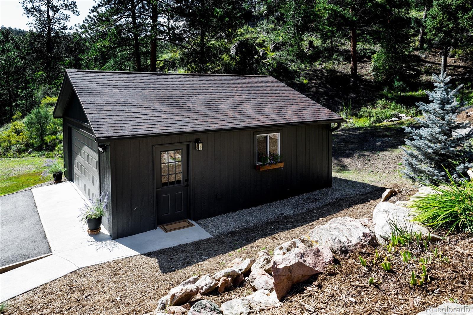 13574 Baird Road Conifer, CO 80433 - Photo 34 of 50 a view of a house with a yard