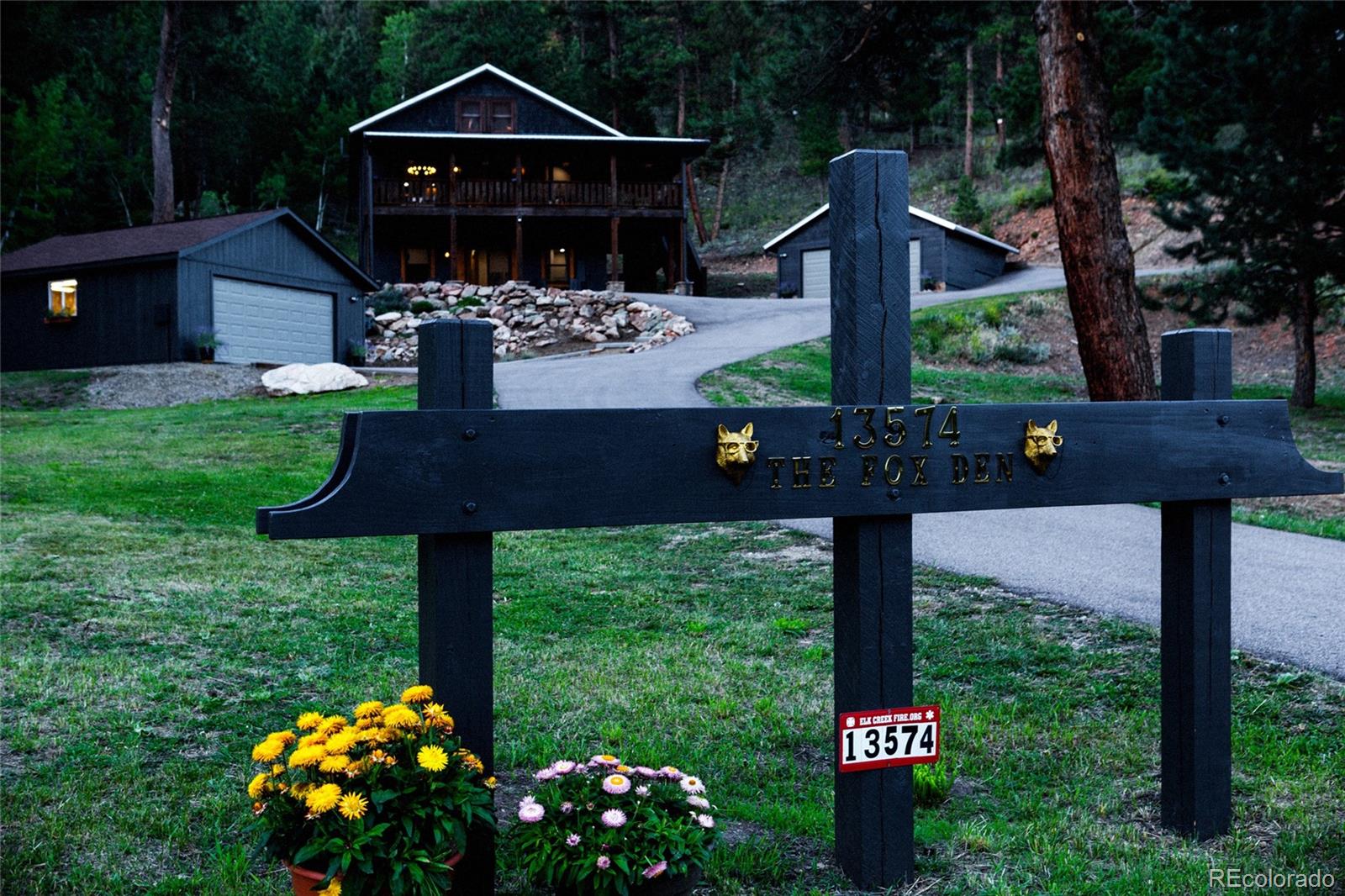 13574 Baird Road Conifer, CO 80433 - Photo 36 of 50 a front view of a house with garden
