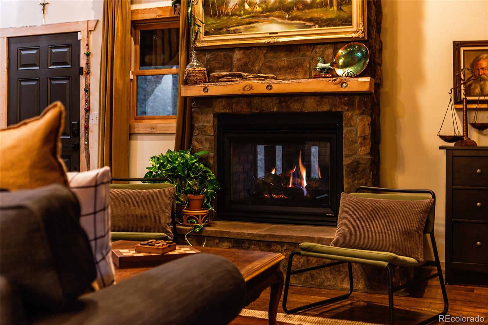 13574 Baird Road Conifer, CO 80433 - Photo 39 of 50 a living room with furniture and a fireplace