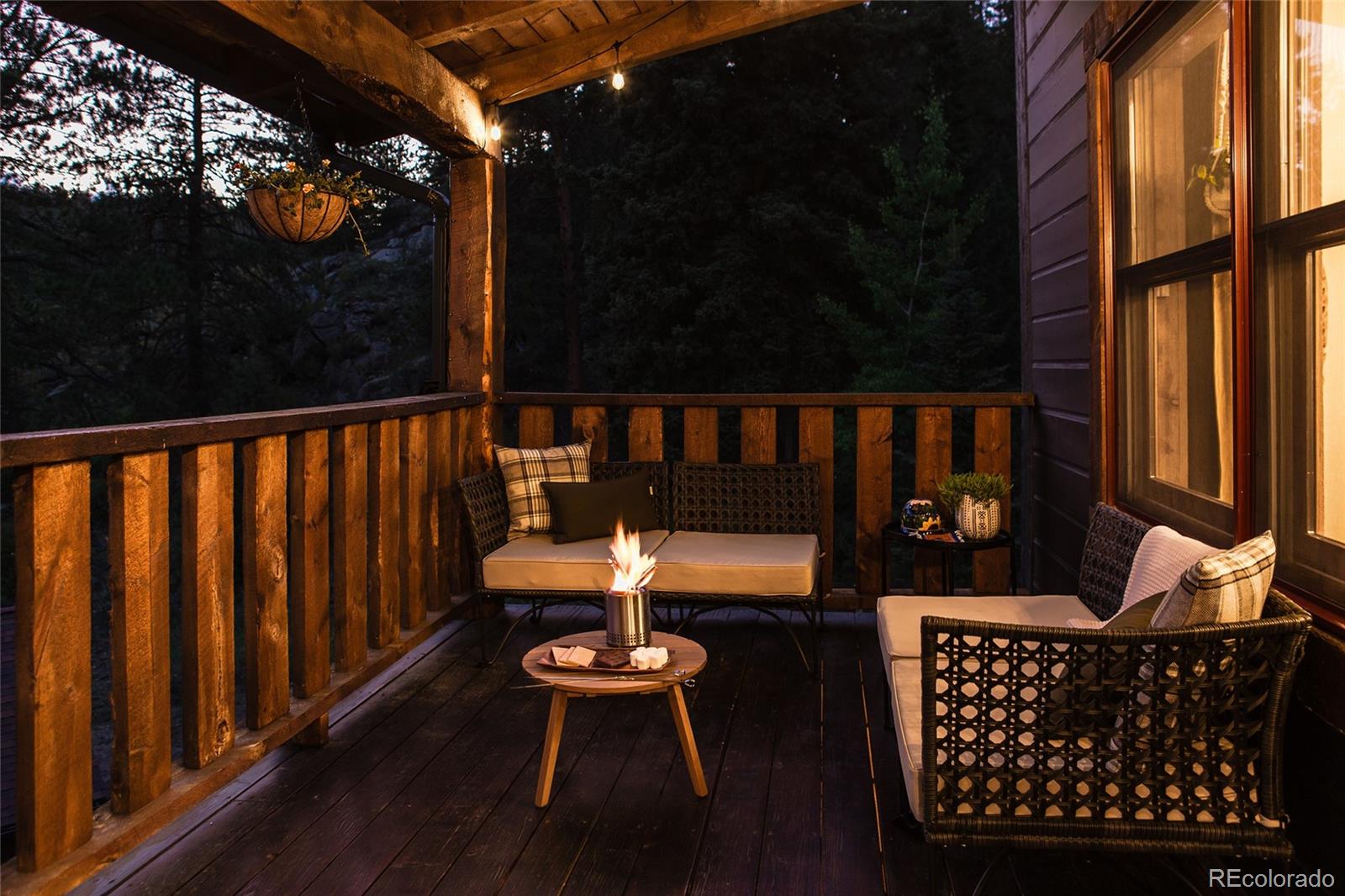13574 Baird Road Conifer, CO 80433 - Photo 40 of 50 a balcony with wooden floor table and chairs