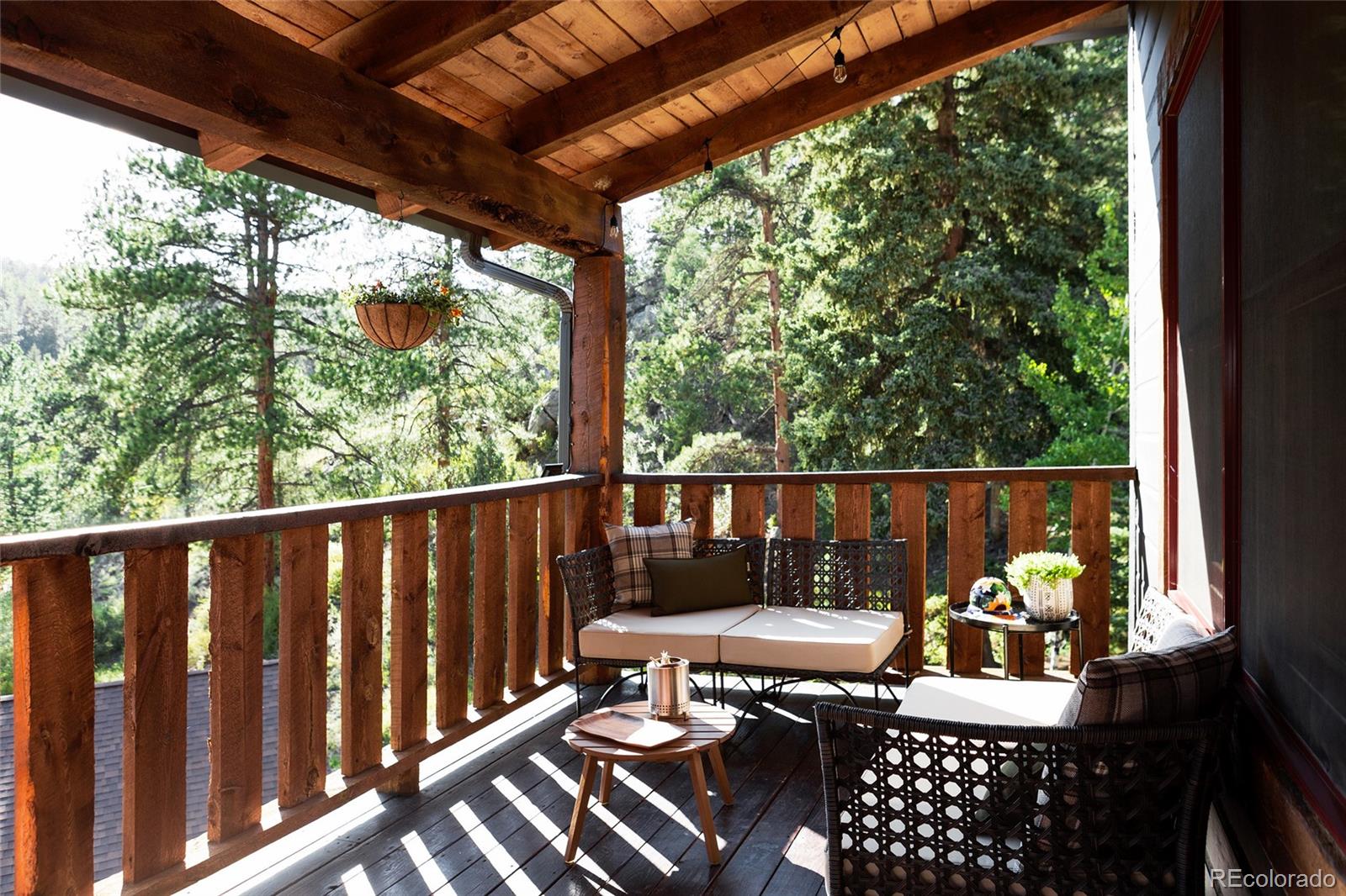13574 Baird Road Conifer, CO 80433 - Photo 4 of 50 a view of a two chairs in the deck