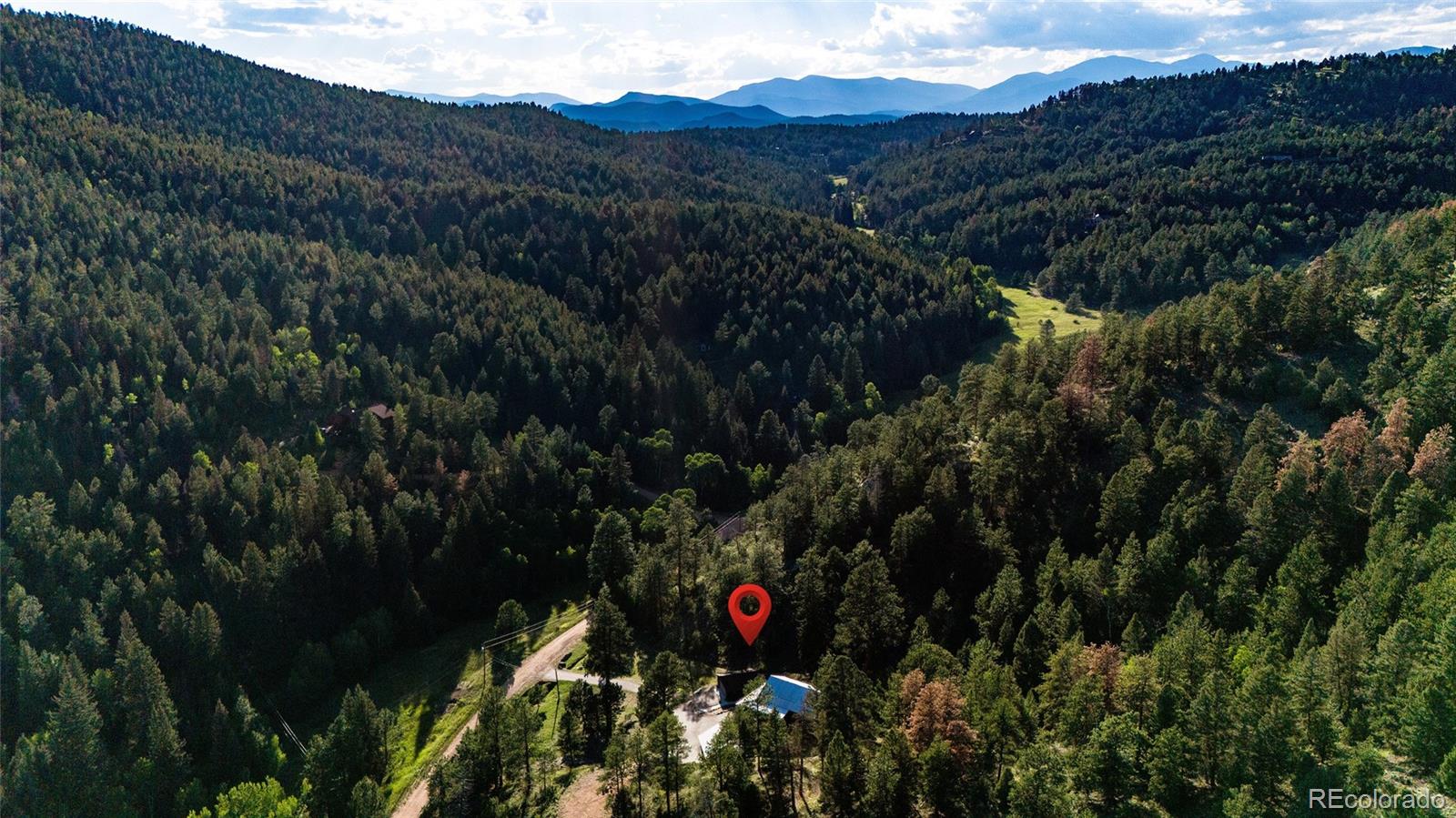 13574 Baird Road Conifer, CO 80433 - Photo 47 of 50 a view of a house with a street