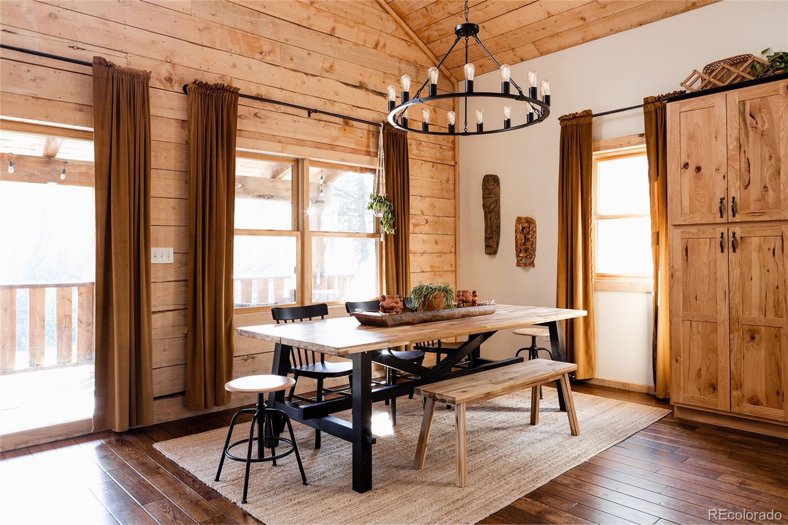 13574 Baird Road Conifer, CO 80433 - Photo 6 of 50 a view of a dining room with furniture window and wooden floor