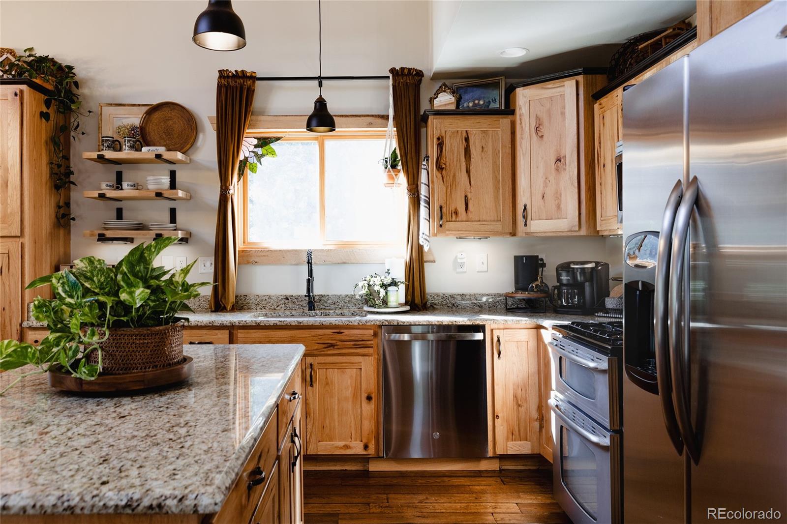 13574 Baird Road Conifer, CO 80433 - Photo 7 of 50 a kitchen with stainless steel appliances granite countertop a sink a stove and a refrigerator