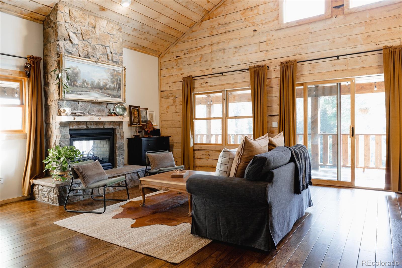 13574 Baird Road Conifer, CO 80433 - Photo 9 of 50 a living room with furniture and a fireplace