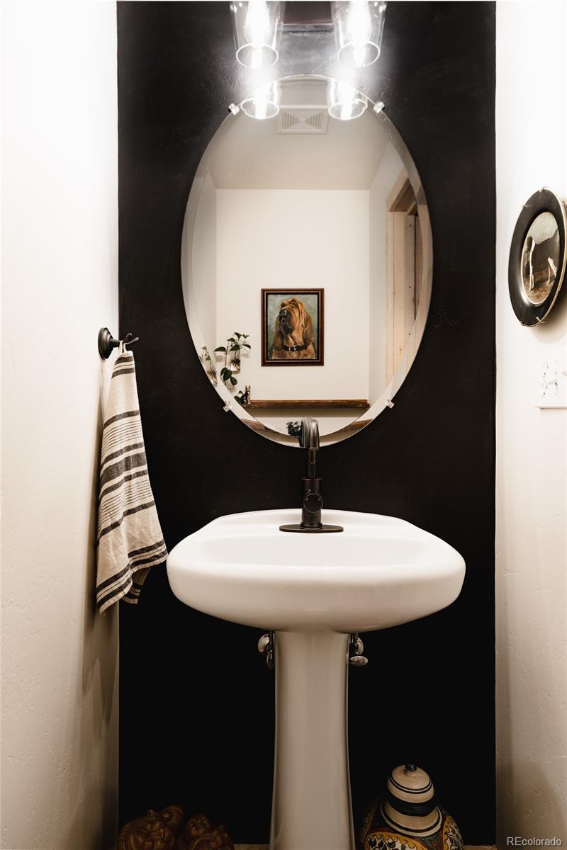 13574 Baird Road Conifer, CO 80433 - Photo 10 of 50 a bathroom with a sink and mirror