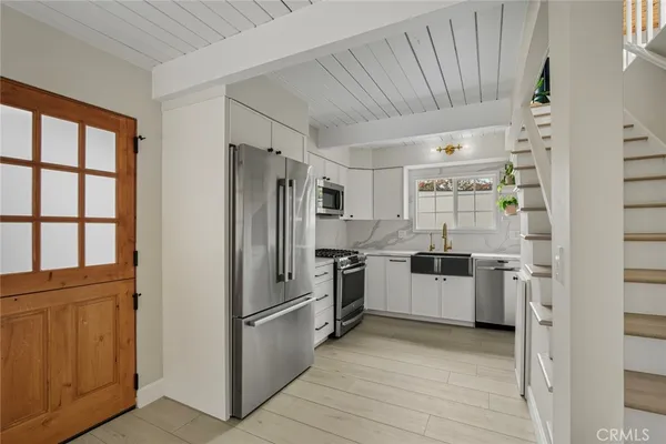 a kitchen with a refrigerator and a sink