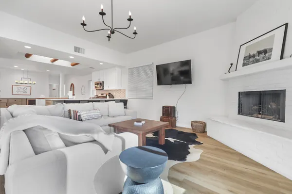 a living room with furniture a flat screen tv and a fireplace