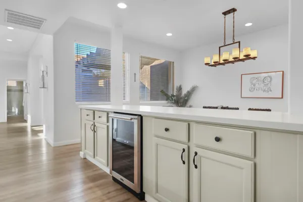 a kitchen with cabinets and wooden floor