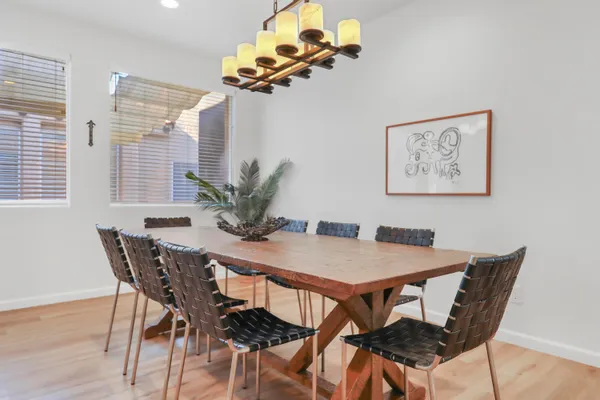 a view of a dining room with furniture and chandelier
