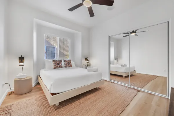 a bedroom with a bed and a chandelier