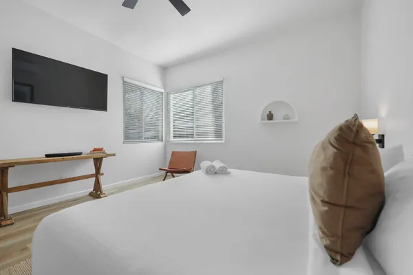 a bedroom with a bed and flat screen tv