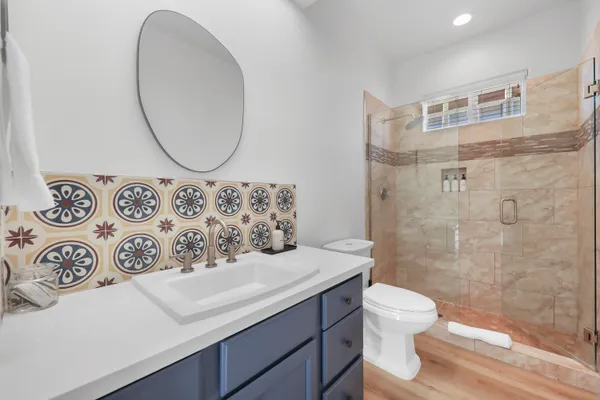 a bathroom with a sink mirror vanity and toilet