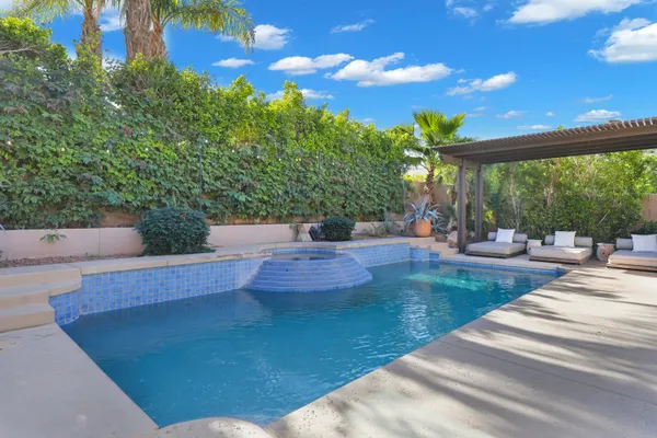 a view of a patio with table and chairs and potted plants