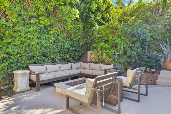 a view of a patio with a table and chairs and couches