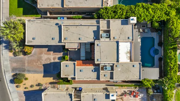 an aerial view of residential houses with outdoor space