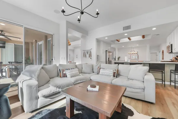 a living room with furniture kitchen view and a table