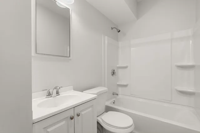 a bathroom with a sink toilet vanity and shower