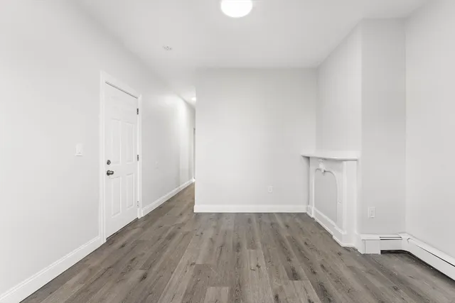 a view of a room with wooden floor