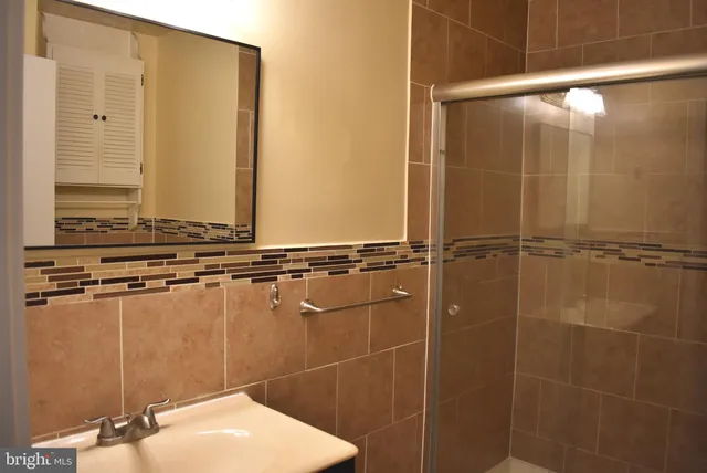 a bathroom with a shower and a sink