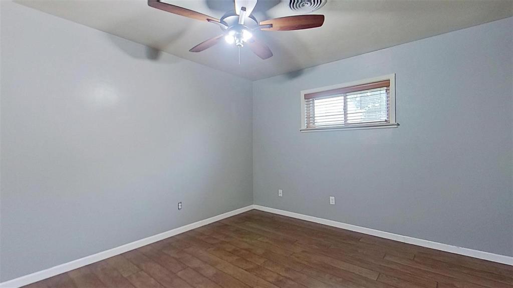 900 Silver Creek Azle Road Azle, TX 76020 - Photo 15 of 27 Room featuring wood-finish flooring, light gray walls, white baseboards, and a window with blinds