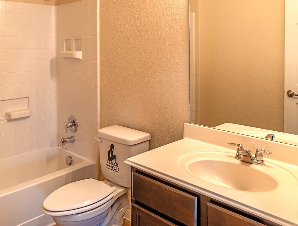 7103 Azalea Square San Antonio, TX 78218 - Photo 11 of 21 a bathroom with a sink a toilet and bathtub