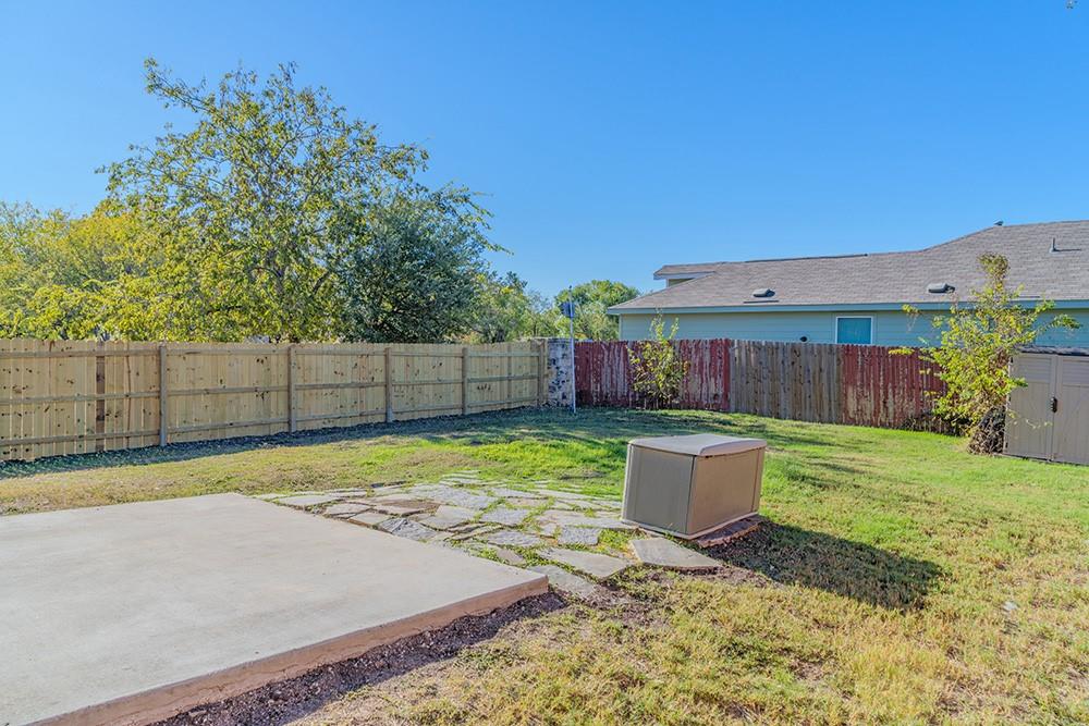 7103 Azalea Square San Antonio, TX 78218 - Photo 18 of 21 a view of a backyard with a small garden and trees