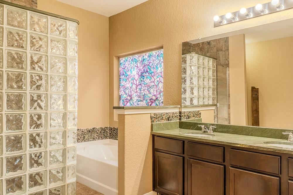7103 Azalea Square San Antonio, TX 78218 - Photo 6 of 21 a bathroom with a sink and a large mirror
