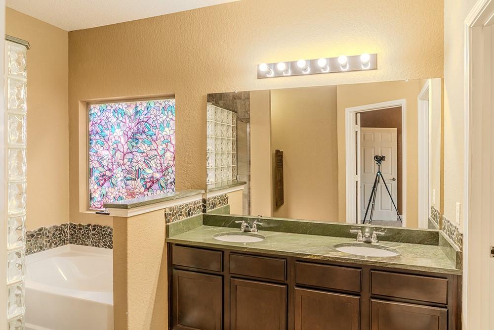 7103 Azalea Square San Antonio, TX 78218 - Photo 7 of 21 a bathroom with a granite countertop sink and a mirror