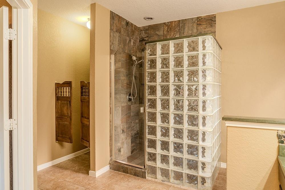 7103 Azalea Square San Antonio, TX 78218 - Photo 8 of 21 a bathroom with a shower and a mirror