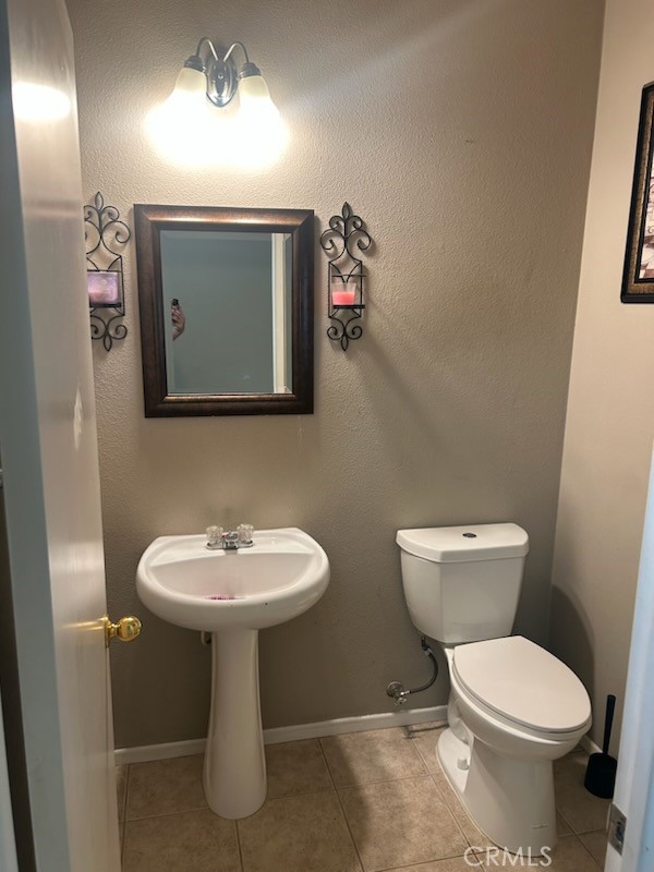 1474 Albillo Loop Perris, CA 92571 - Photo 11 of 13 a bathroom with a toilet sink and mirror