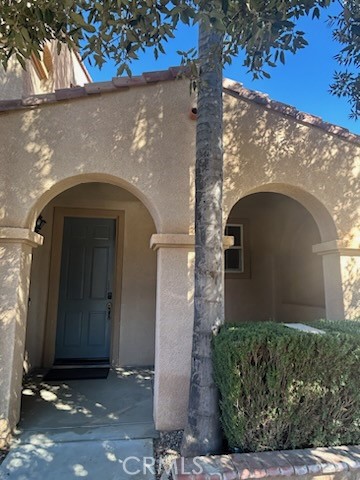 1474 Albillo Loop Perris, CA 92571 - Photo 2 of 13 a front view of a house with garden