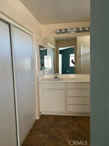 a bathroom with a sink vanity and mirror