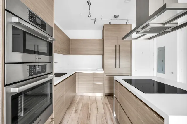 a kitchen with stainless steel appliances kitchen island granite countertop a sink and cabinets